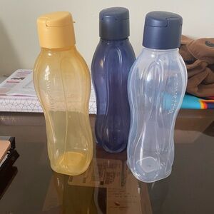 Tupperware Trio: Yellow, Blue, and Clear Bottles